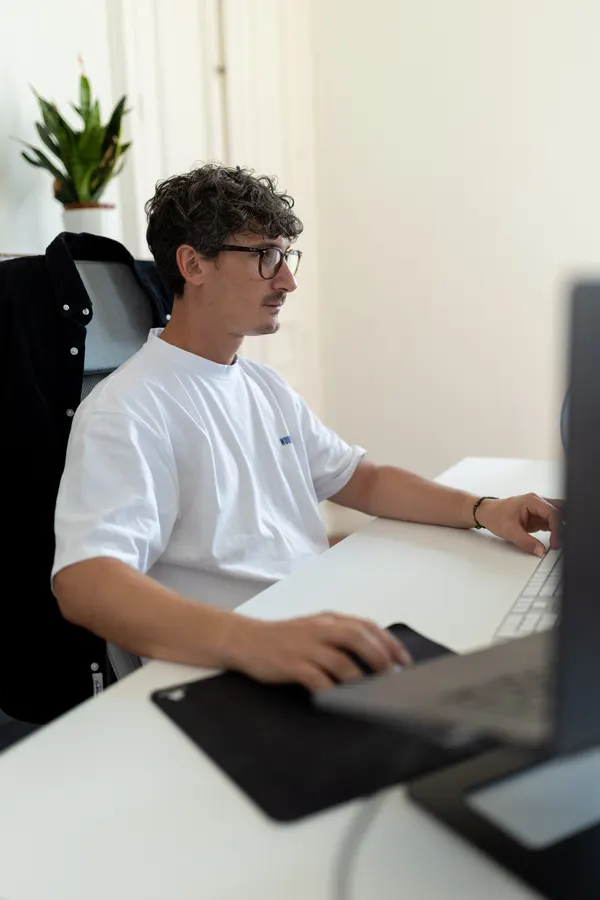 A team member focused on their laptop